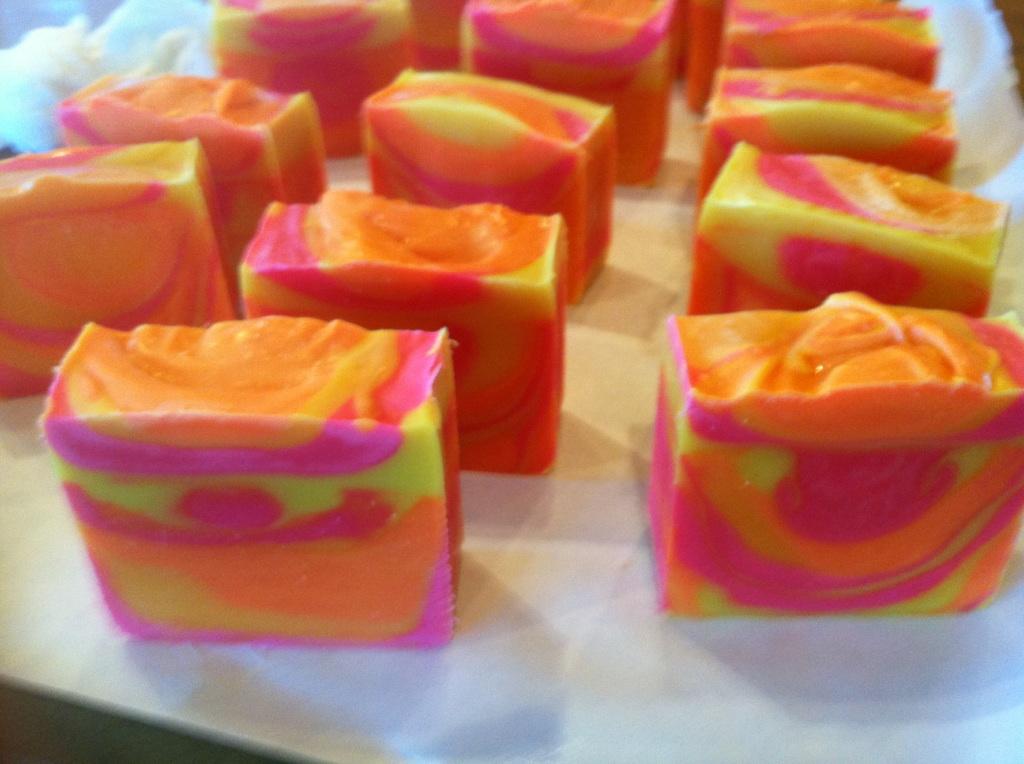 Brilliant neon orange, pink, and yellow handmade soap.